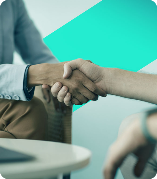 Close-up of two people shaking hands, emphasizing human connection and collaboration.