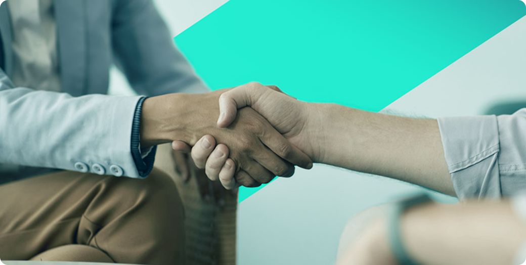 Close-up of two people shaking hands, emphasizing human connection and collaboration.